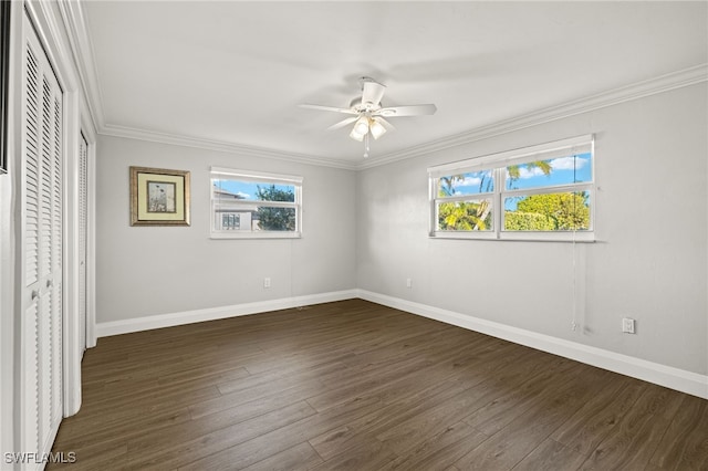 unfurnished bedroom with a closet, ornamental molding, dark hardwood / wood-style floors, and ceiling fan