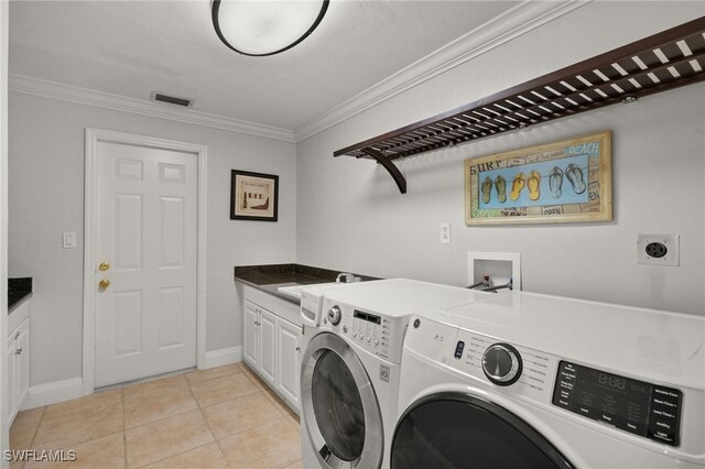 clothes washing area with separate washer and dryer, sink, cabinets, light tile patterned floors, and crown molding