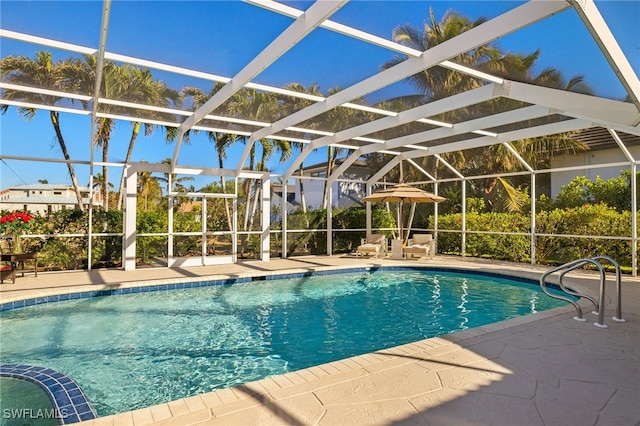 view of pool with a lanai and a patio