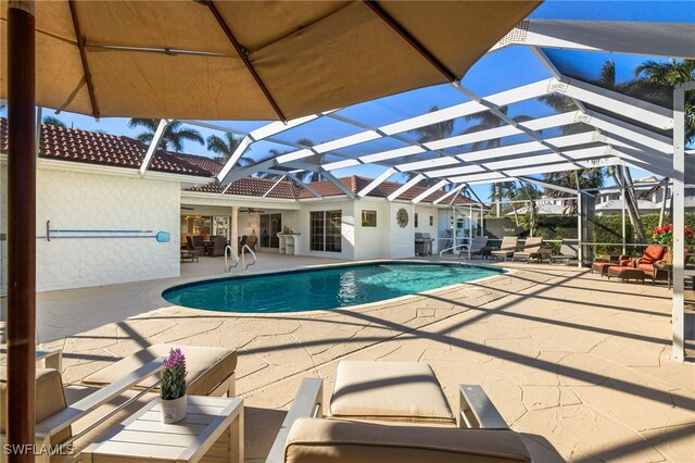 view of swimming pool with a patio area and glass enclosure