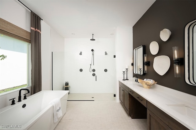 bathroom with vanity, tile patterned flooring, and plus walk in shower