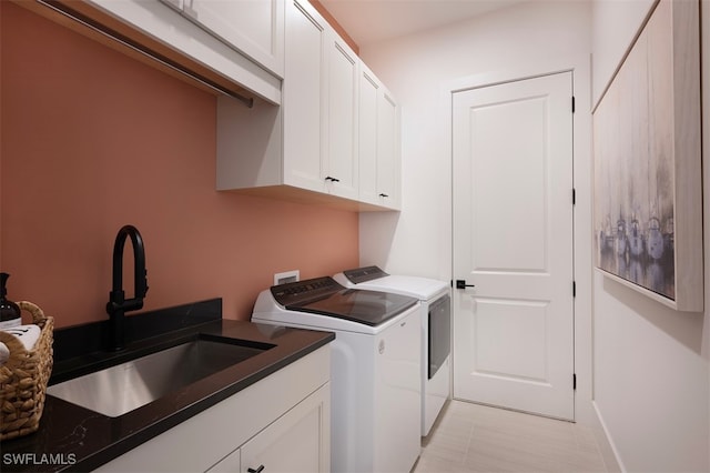 washroom with washer and clothes dryer, a sink, and cabinet space