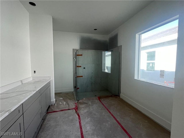 bathroom featuring vanity and a tile shower