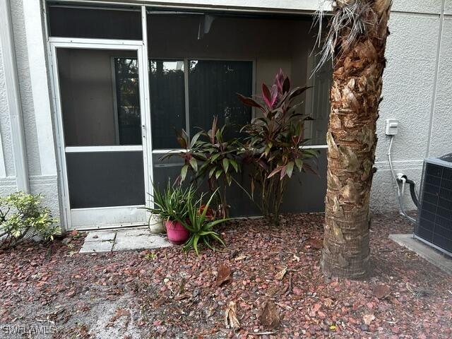 view of side of property with central AC unit