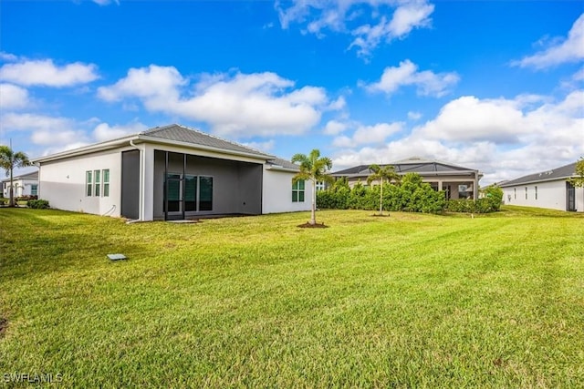 rear view of house featuring a lawn