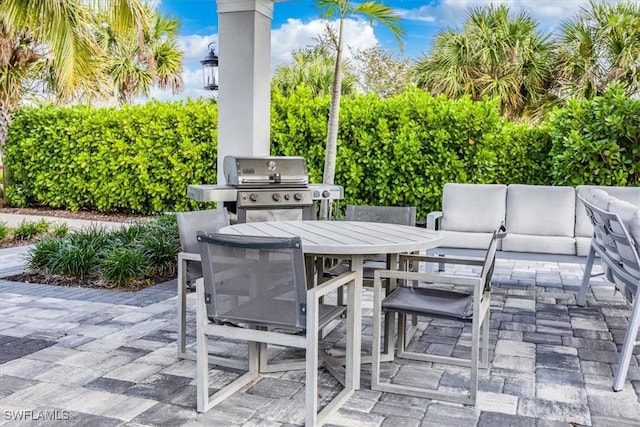 view of patio with an outdoor living space and area for grilling