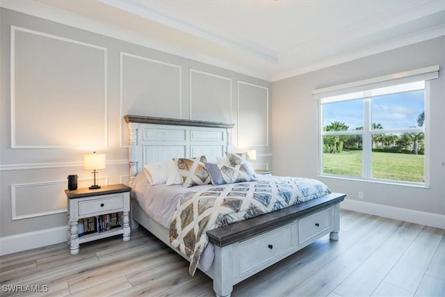 bedroom featuring crown molding and light hardwood / wood-style floors