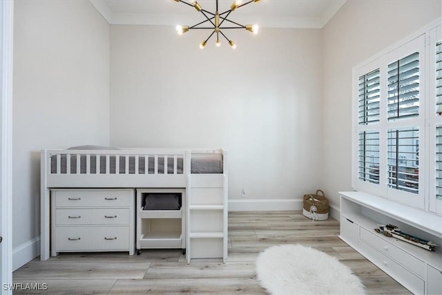 unfurnished bedroom with ornamental molding, light wood-type flooring, and a notable chandelier