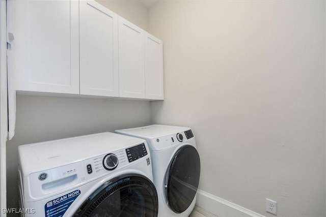 laundry area featuring cabinets and washing machine and dryer