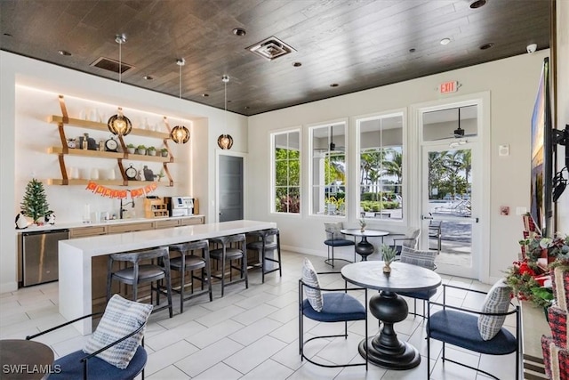 interior space with ceiling fan, light tile patterned flooring, and wood ceiling