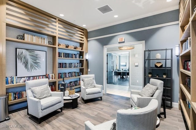 sitting room with hardwood / wood-style flooring