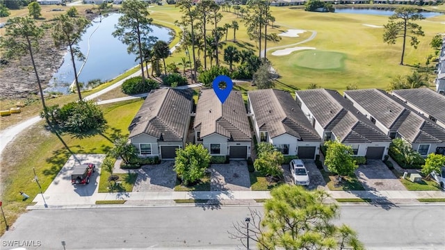 birds eye view of property featuring golf course view, a water view, and a residential view