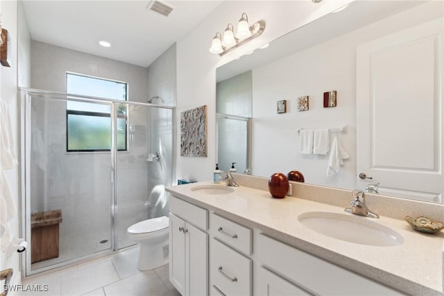 bathroom with vanity, tile patterned flooring, a shower with shower door, and toilet