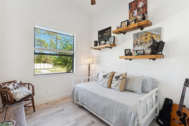 bedroom with light wood-style flooring and baseboards