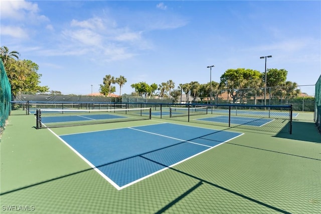 view of tennis court featuring basketball hoop