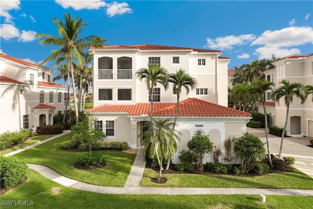 mediterranean / spanish-style house featuring a front yard