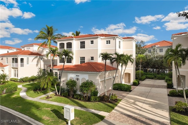 mediterranean / spanish-style home with a front lawn