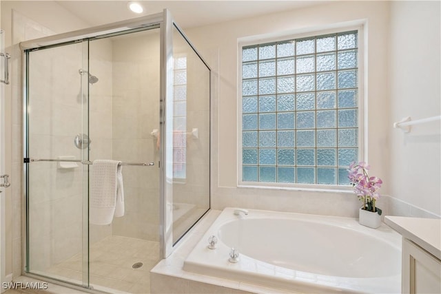 bathroom featuring vanity and separate shower and tub