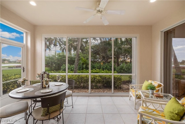 sunroom / solarium featuring ceiling fan