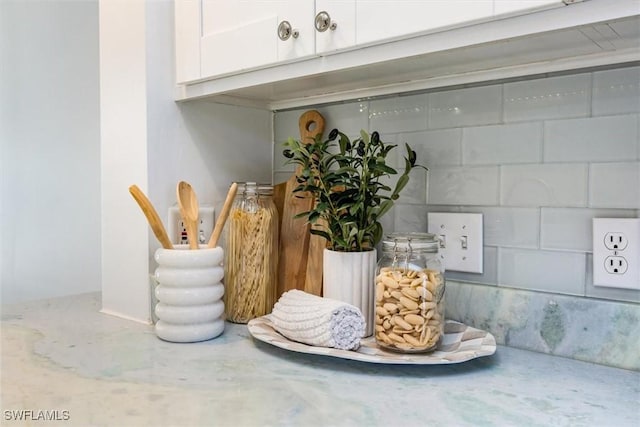 interior details with white cabinetry and concrete block wall