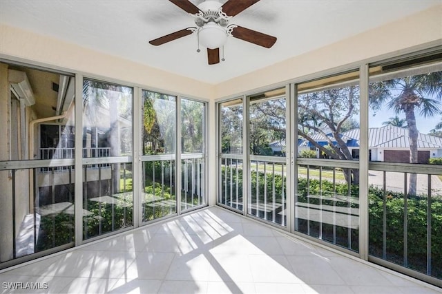 unfurnished sunroom featuring ceiling fan