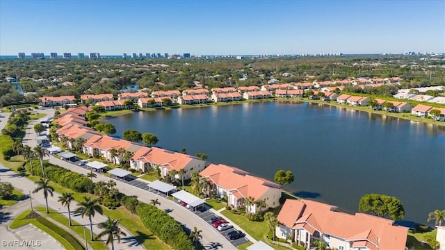 drone / aerial view with a water view and a residential view