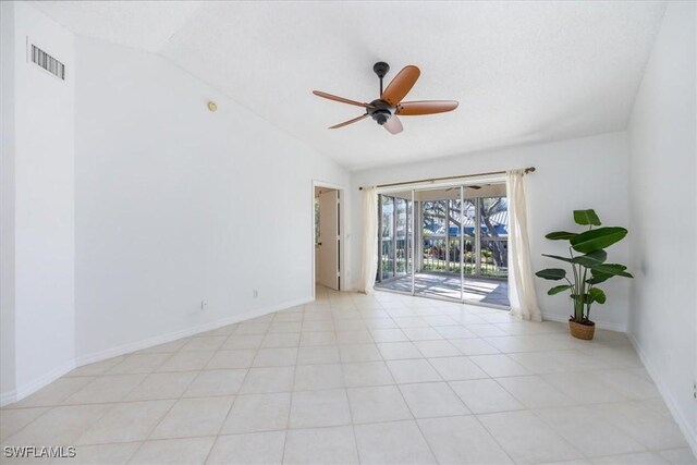 unfurnished room with vaulted ceiling, baseboards, visible vents, and a ceiling fan