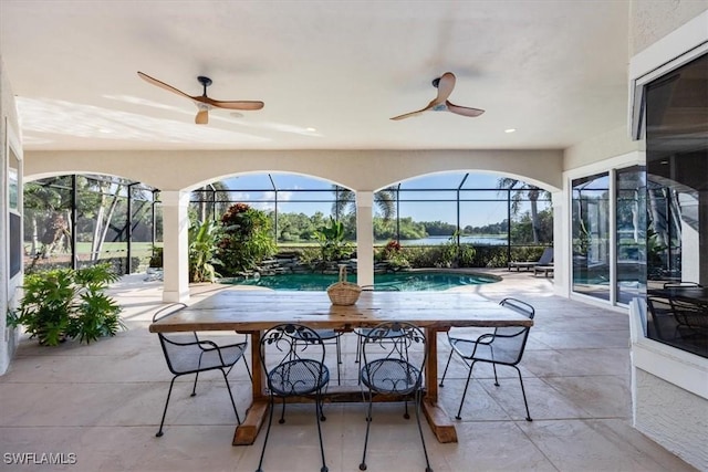 view of patio / terrace featuring glass enclosure and ceiling fan