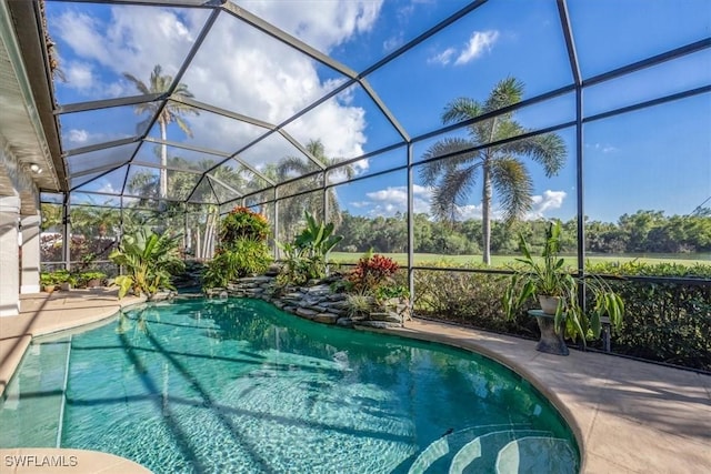 view of pool with a patio area and a lanai