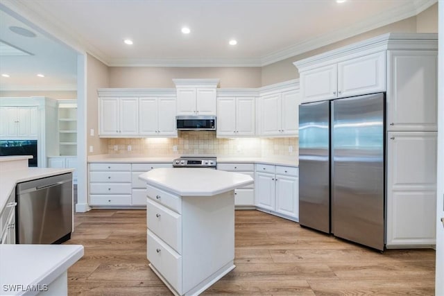 kitchen featuring stainless steel appliances, white cabinetry, and light hardwood / wood-style floors