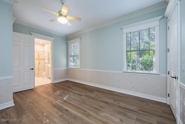 unfurnished bedroom featuring dark hardwood / wood-style flooring, multiple windows, and ceiling fan