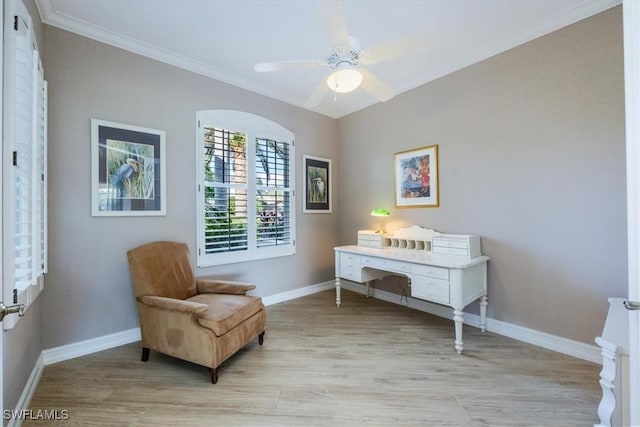 living area with ceiling fan, crown molding, and light hardwood / wood-style flooring