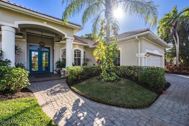 doorway to property featuring french doors and a garage