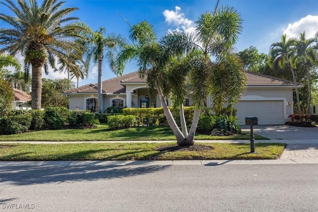 view of front of home featuring a front lawn and a garage