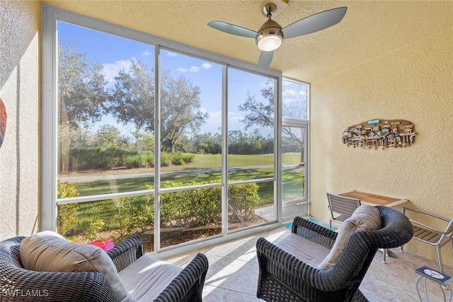 sunroom / solarium featuring ceiling fan