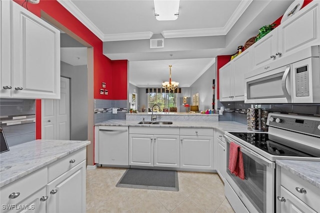 kitchen featuring white cabinets, white appliances, and sink