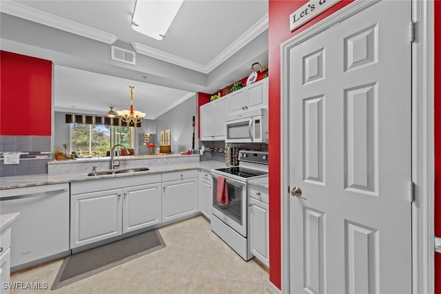 kitchen with white cabinetry, sink, tasteful backsplash, crown molding, and white appliances