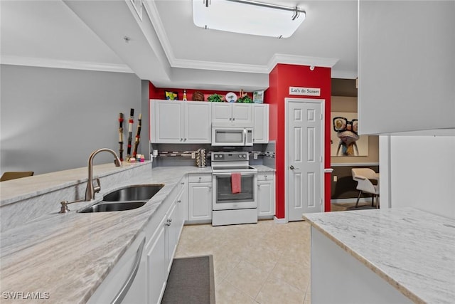 kitchen with light stone counters, white appliances, crown molding, sink, and white cabinets