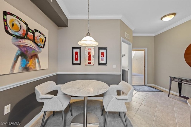 tiled dining space featuring ornamental molding