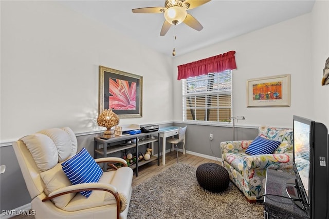 living area with ceiling fan and light hardwood / wood-style flooring