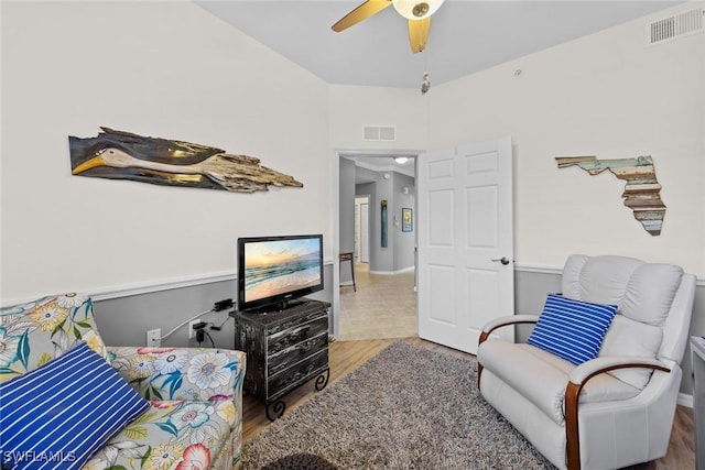 living room with hardwood / wood-style flooring and ceiling fan