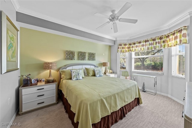 carpeted bedroom featuring ceiling fan and ornamental molding