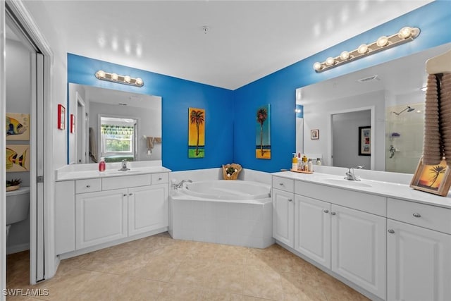 bathroom with tile patterned floors, vanity, and shower with separate bathtub