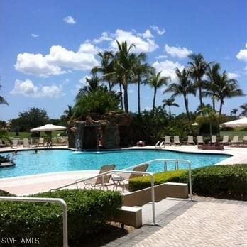 view of swimming pool featuring a patio and pool water feature