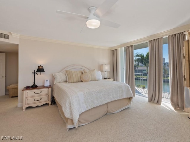 bedroom with light carpet, a water view, ceiling fan, access to exterior, and ornamental molding