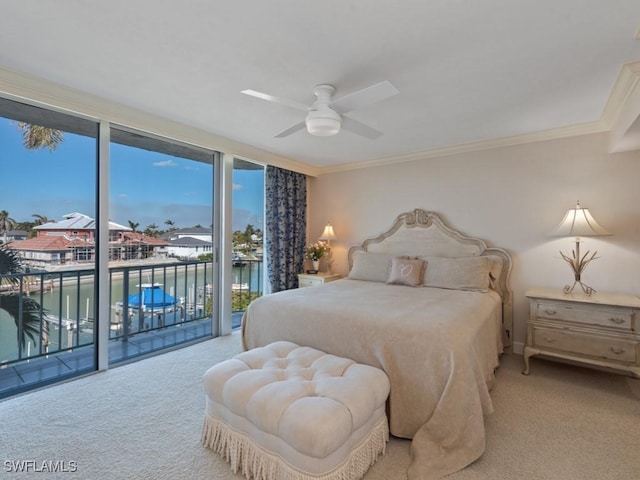 bedroom featuring light carpet, a water view, crown molding, ceiling fan, and access to exterior