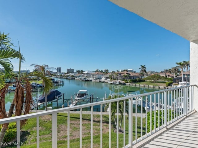 balcony featuring a water view and a dock