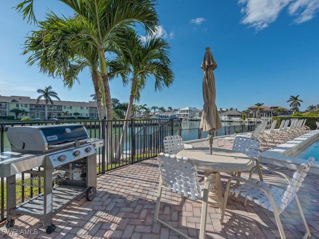 view of patio / terrace featuring a water view and a dock