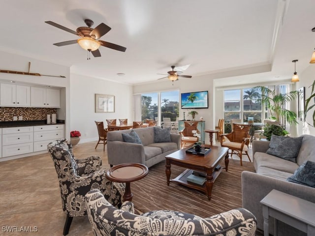 living room featuring plenty of natural light, crown molding, and ceiling fan