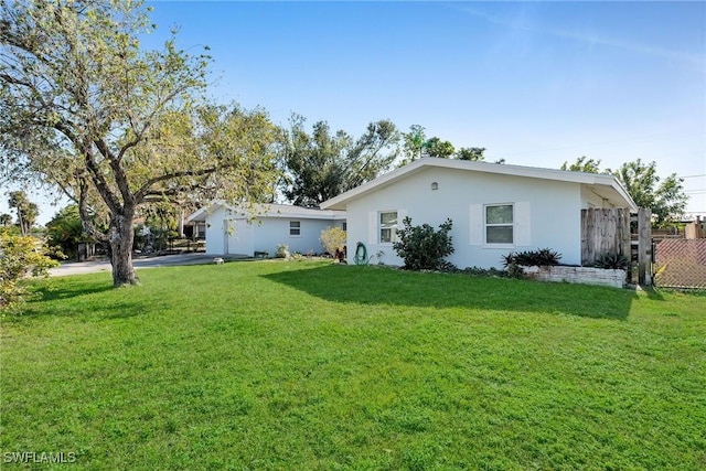 rear view of house with a yard